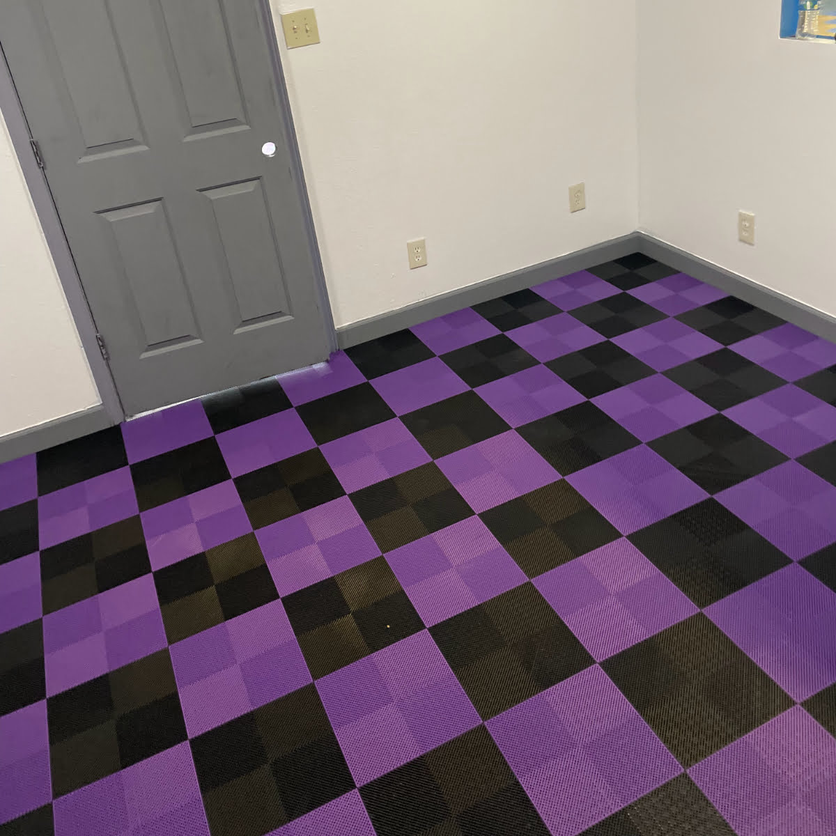 Garage workshop room using our Perforated black and purple tiles.