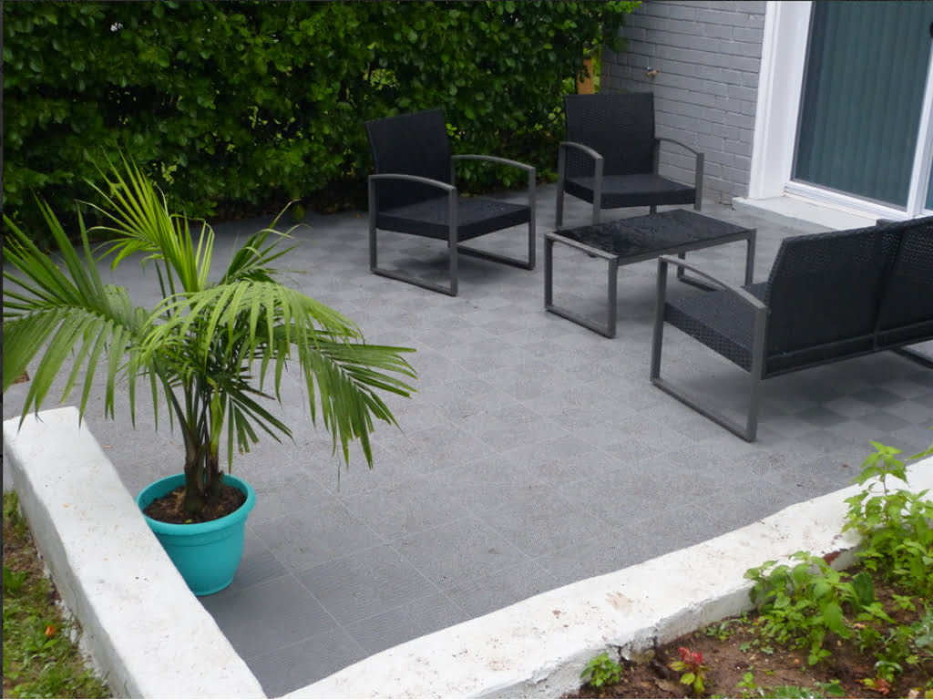 Outdoor lounge area with our interlocking patio perforated gray tile.